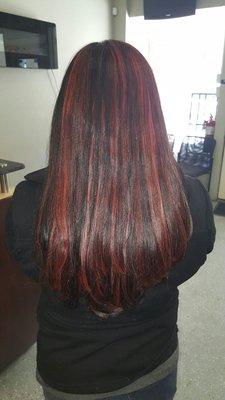 My hair with red highlights done at this salon.