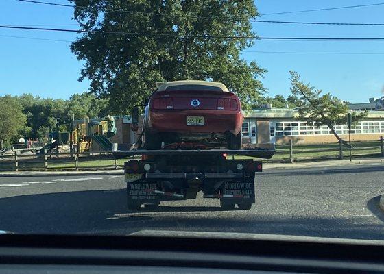 Busted Mustang being towed