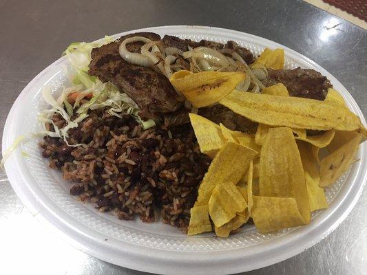 Steak with red beans and rice and fried plantain chips