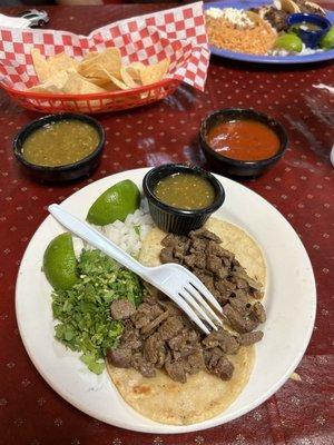 Steak tacos, onions, and cilantro.