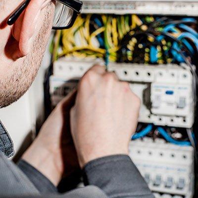 Technician working on an electrical breaker box