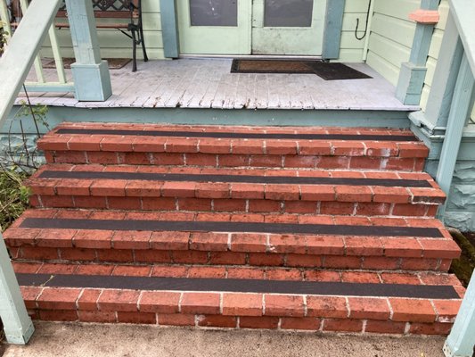 Brick steps after pressure washing with grip strips added.