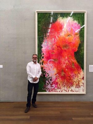 Stephen Johnson standing in front of Firelei Baez painting on paper framed for the Perez Art Museum, Miami. Framed by Stephen Johnson team.