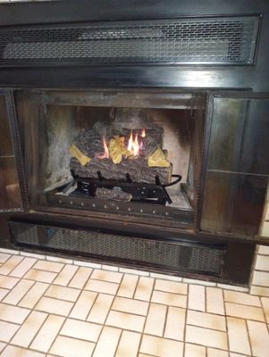 Gas line run into fireplace. Natural gas logs set them installed.