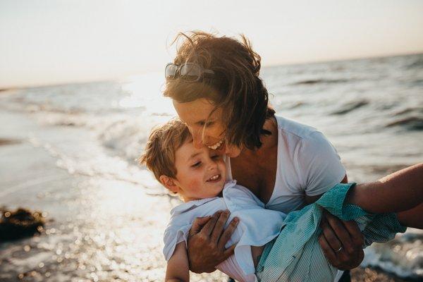 Mother holding child on the beach