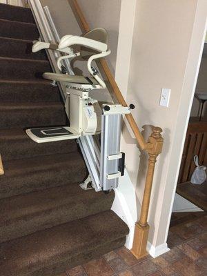 Pinnacle stair lift with folding rail installed on steps.