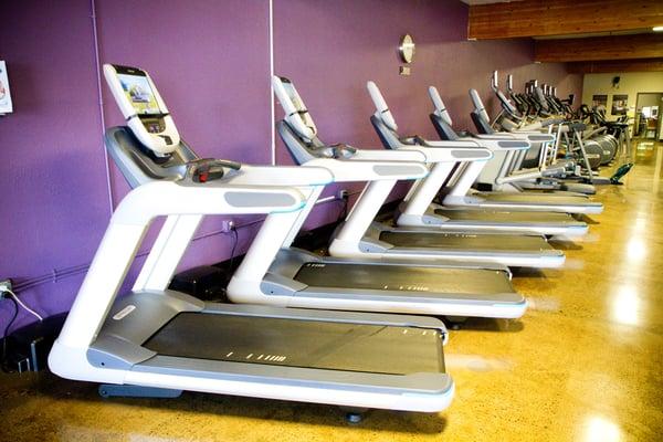 Precor cardio equipment with touchscreen Preva consoles.