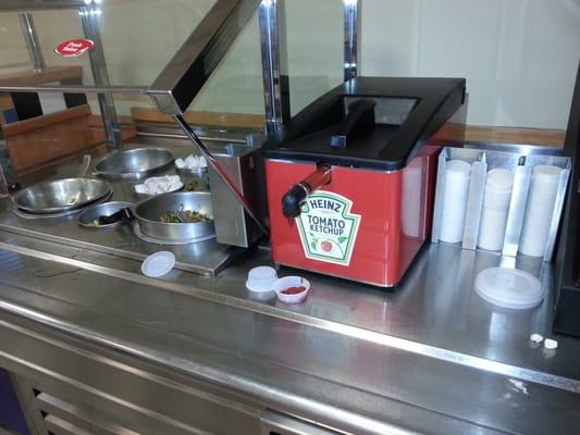 The manager has to make sure that the condiments area is always clean. This location has dirty sections.