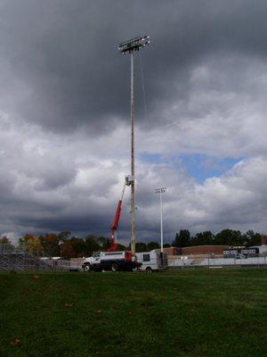 Working on top of 120ft Stadium Light Pole tower