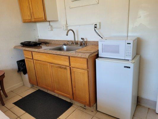 Full-sized bed, kitchenette, and cable television