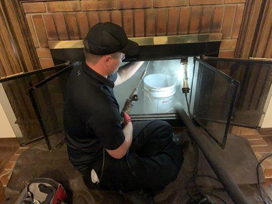 Our certified Chimney Sweep (owner) cleaning a chimney.