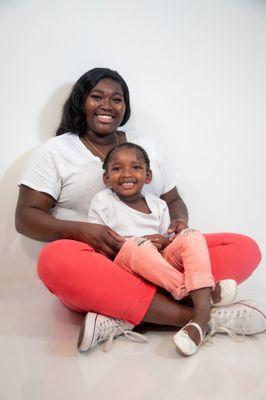 Mother and daughter photos with matching white shirt and pink pants.