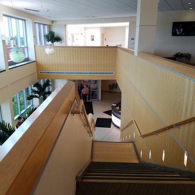 view of stairway from the second floor waiting room down to the main entrance