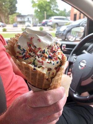 Birthday cake ice cream with sprinkles in waffle cone