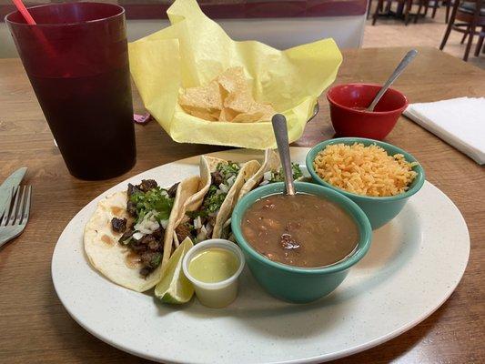 Beef fajita tacos plate with charro beans.