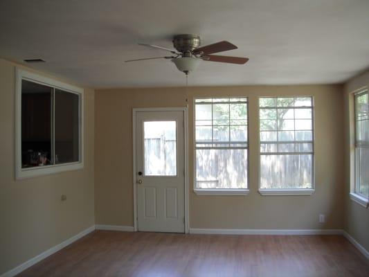 After - Sunroom: New flooring, paint, ceiling and fans.