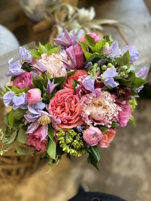 Cheerful and girly arrangement featuring candy stripe peonies, sweet peas, and garden roses