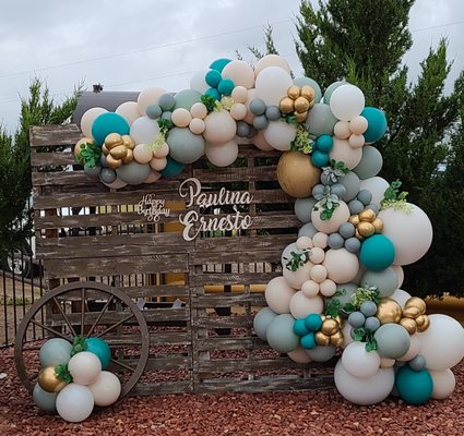 Outdoor balloon garlands with greenery accents