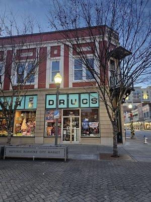 The outside of the building where the Gift Niche is located and with the original sign of what seemed to have been a Drug store.