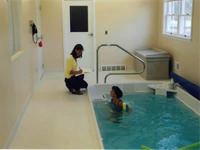 Denise Didio Buher, PT, DPT working with a patient in our pool