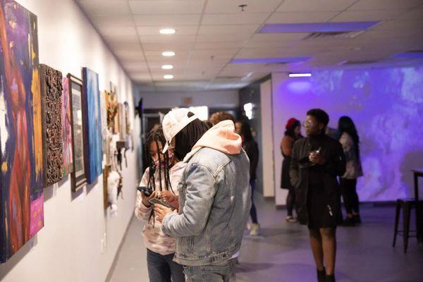 Guests enjoying our Local Artistry gallery wall.