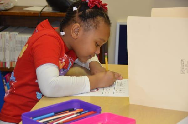 A 5k student working on math problems.