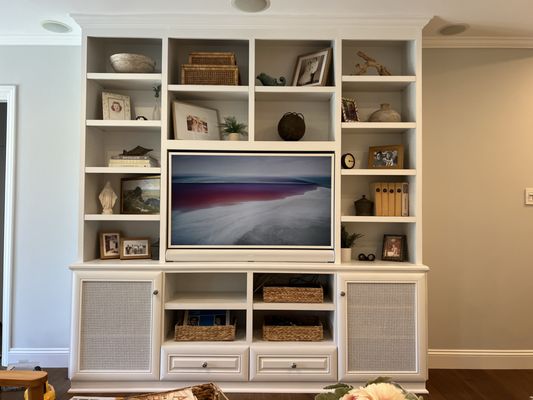 Frame TV with white bezel and white Sonos Arc. (Also with Sonos Amp for rear ceiling speakers and Sonos Sub)