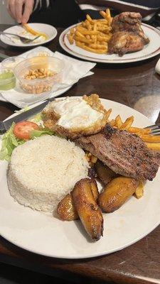 Steak, eggs, rice, fries, plantains and salad