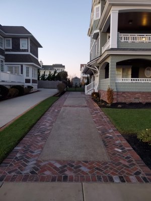 Finished Concrete drive way with brick paver outline