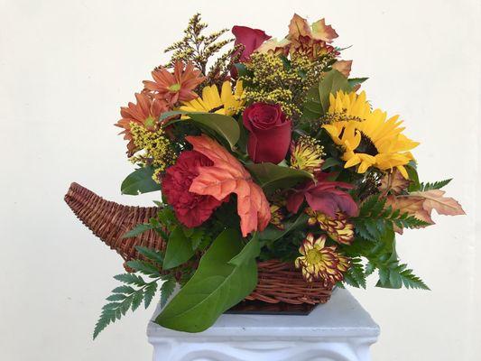 Large Thanksgiving cornucopia basket with 3 Sunflowers, 3-4 roses and mix of seasonal flowers. Please call for pricing details.