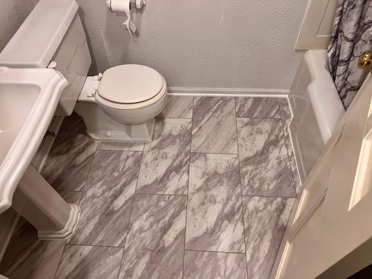 LVT over old Tile. also did corner round and caulking around tub toilet and sink base