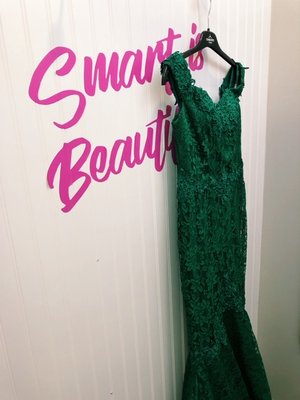 A beautiful green lace dress shown in the fitting room of our showroom!