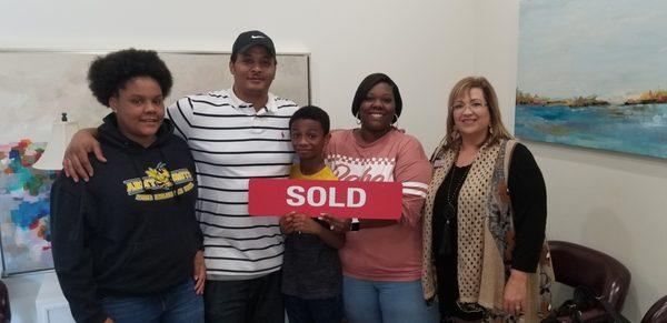 The Tucker's super happy at the closing of their first home with Lynn Martin.