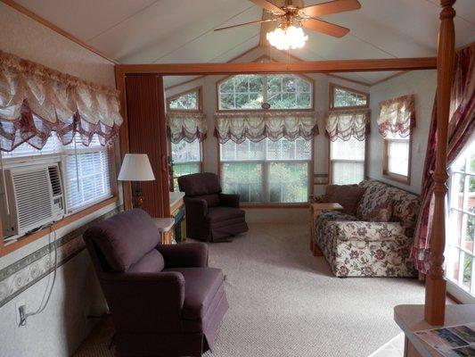 Most livingrooms, such as this in cabin #7, have glass patio doors leading out to the deck & each cabin has a picnic table & charcoal grill