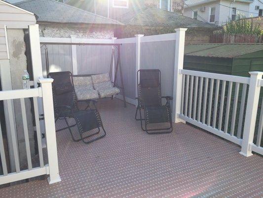 Dual tone PVC railings with matching fencing on a wooden deck