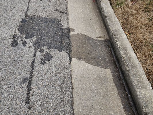 Oil on street from car breaking down on side of road in freezing Dec. 2023