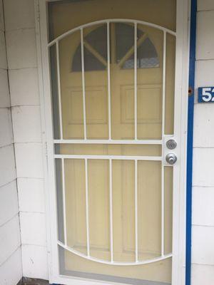 Photo of security door installed over existing trim.