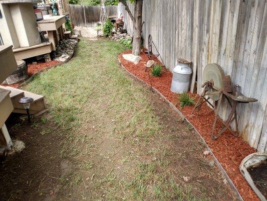 Rocks and mulch war added also taking out weds with medal edging keeping everything in place.