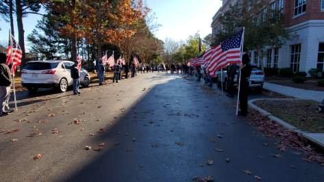 Patriot Guard Flag line to welcome Army SSG Van Booth during his final leg of 3000 XCountry walk for veterans.