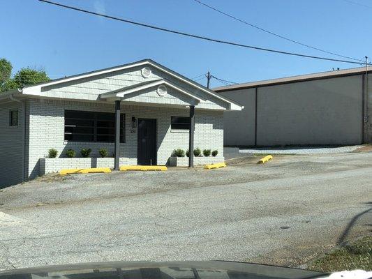 Building and parking view. Please park in grave area and enter the back entrance where you will find a waiting area.