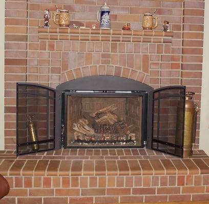 Fireplace with doors open.