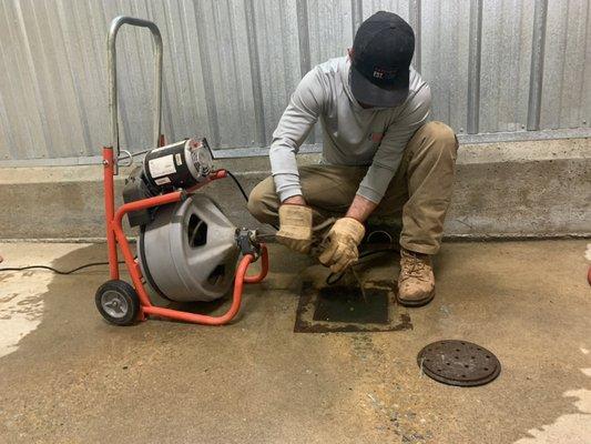 Our technician is using a cable machine to unclog a drain.