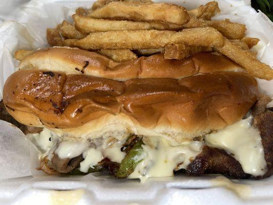 Philly steak sandwich and fries