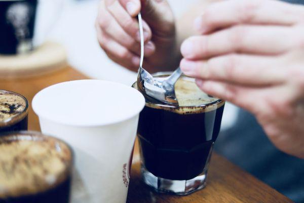 Removing the coffee "crust" to reveal the true aroma of the brewed coffee