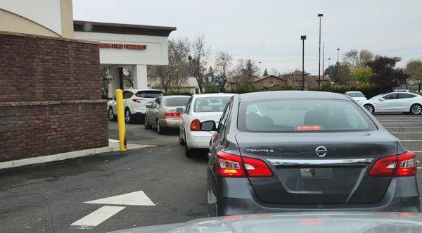 Short lines like this easily exceed 30 minutes plus. The drive-through is not a service oriented priority for this location.