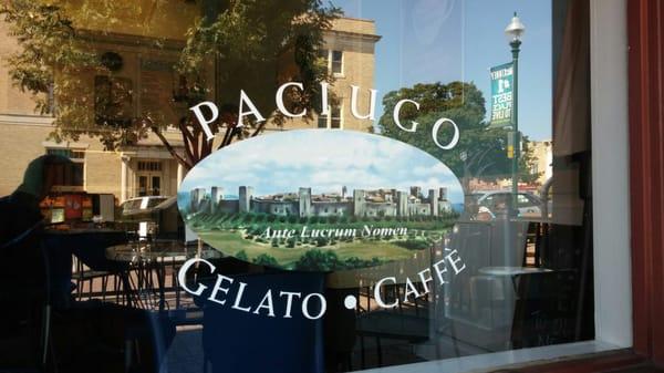 Store logo on front window with a reflection of the old downtown McKinney courthouse across the street.