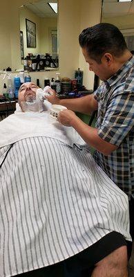 Barber Darryl prepping for old fashion blade shave