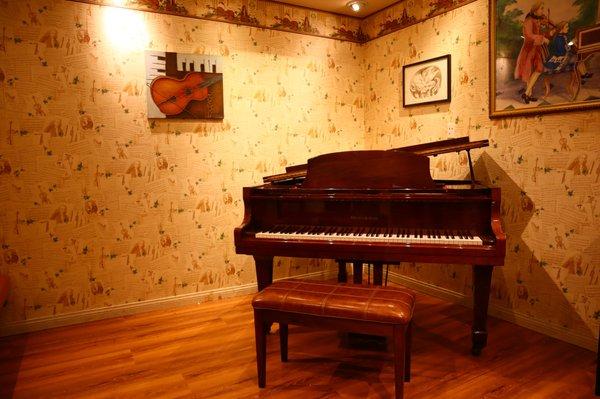 Teaching studios with beautiful upright and baby-grand pianos.