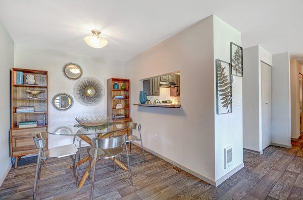 Separate dining spaces and wood-inspired flooring at Beacon at Center Apartments in Everett WA