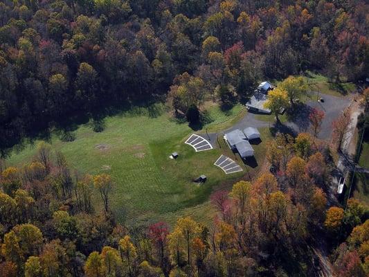 A recent aerial view of our 2 trap ranges, the small club house, and the big one with the outdoor grill house behind it.